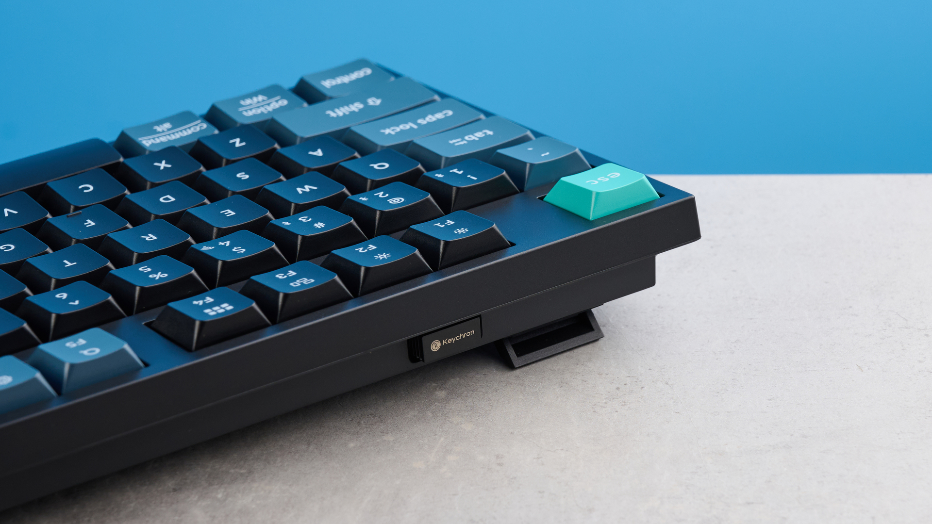 Keychron B36 keyboard and Keychron BM25 mouse photographed in front of a blue background.