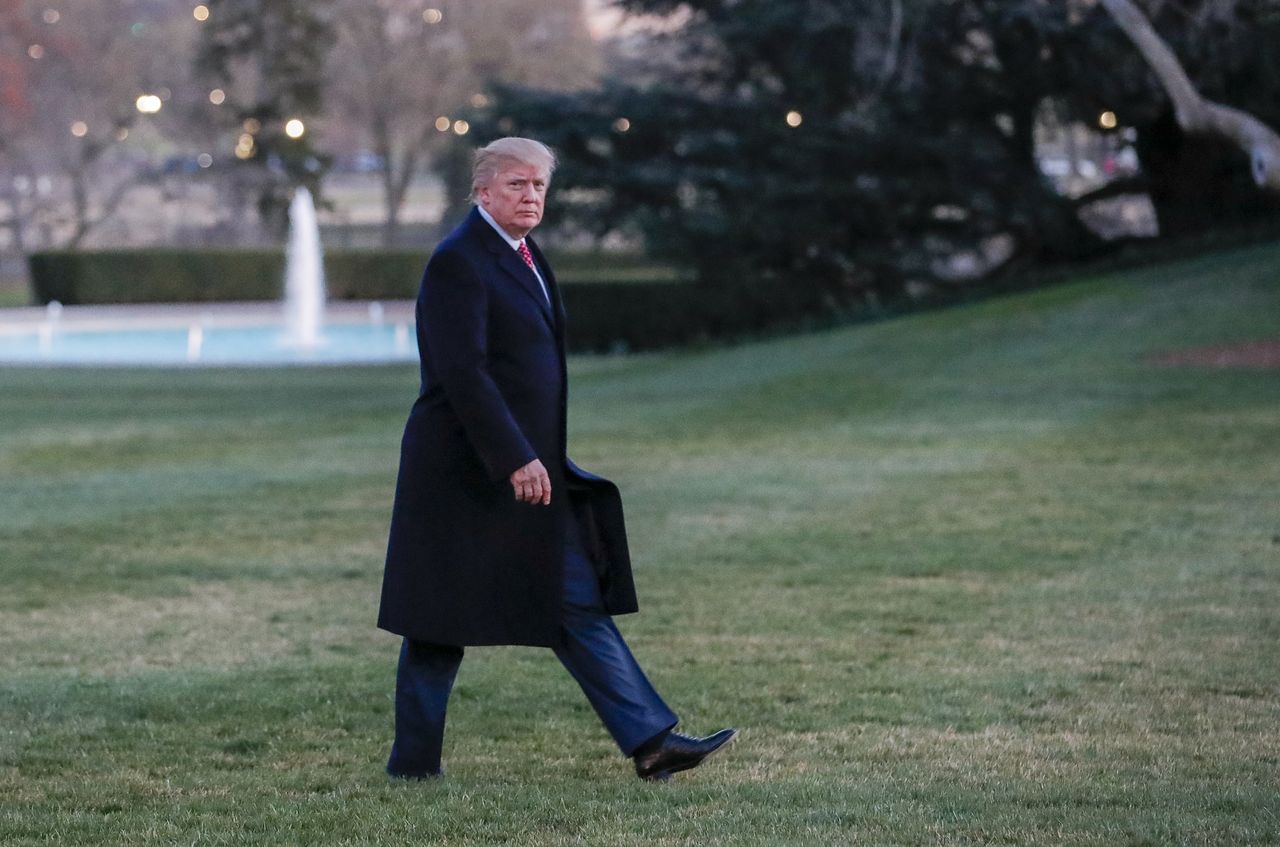 President Trump walks across the White House lawn