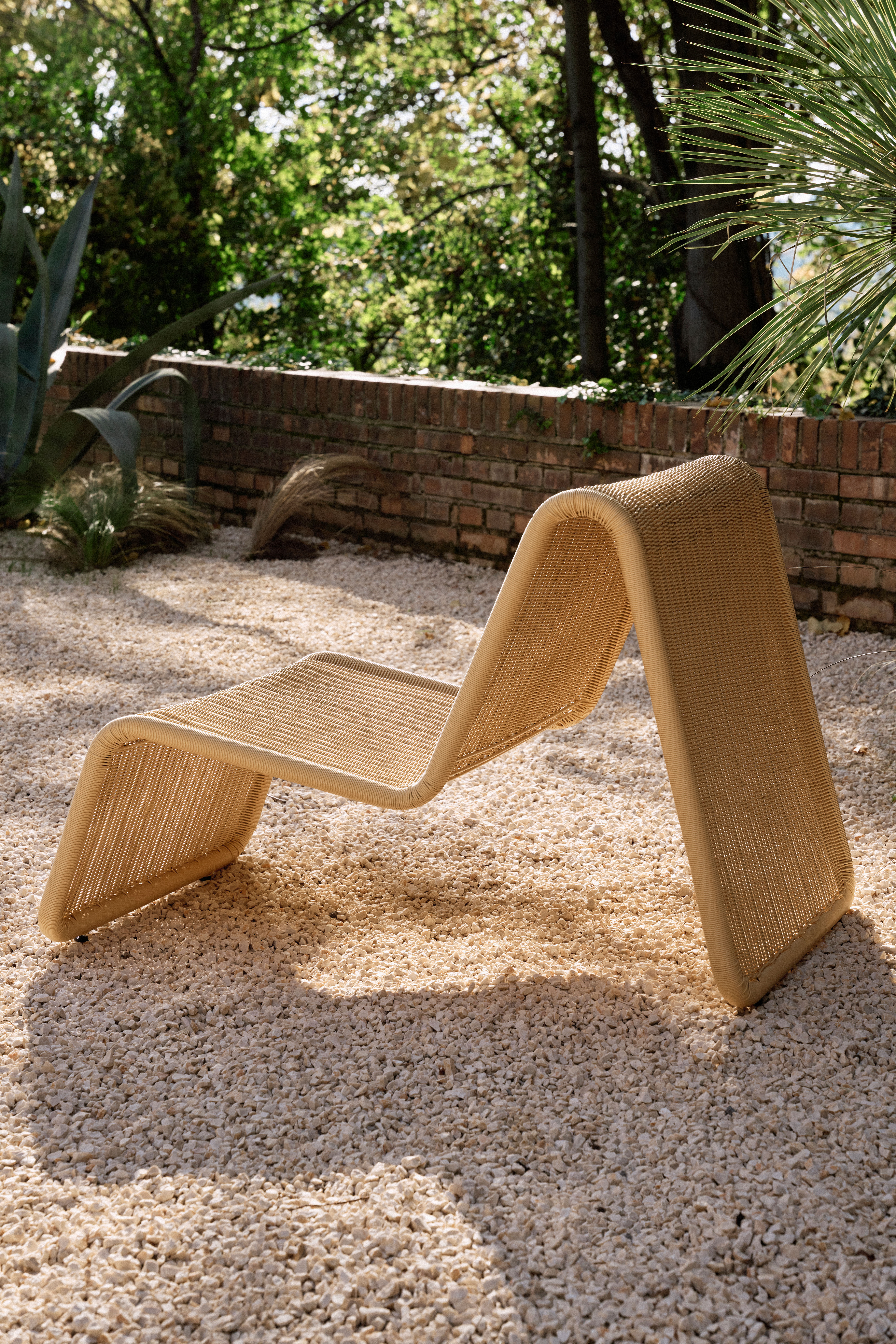 Rattan chairs by Gubi and Bonacina photographed poolside in a garden