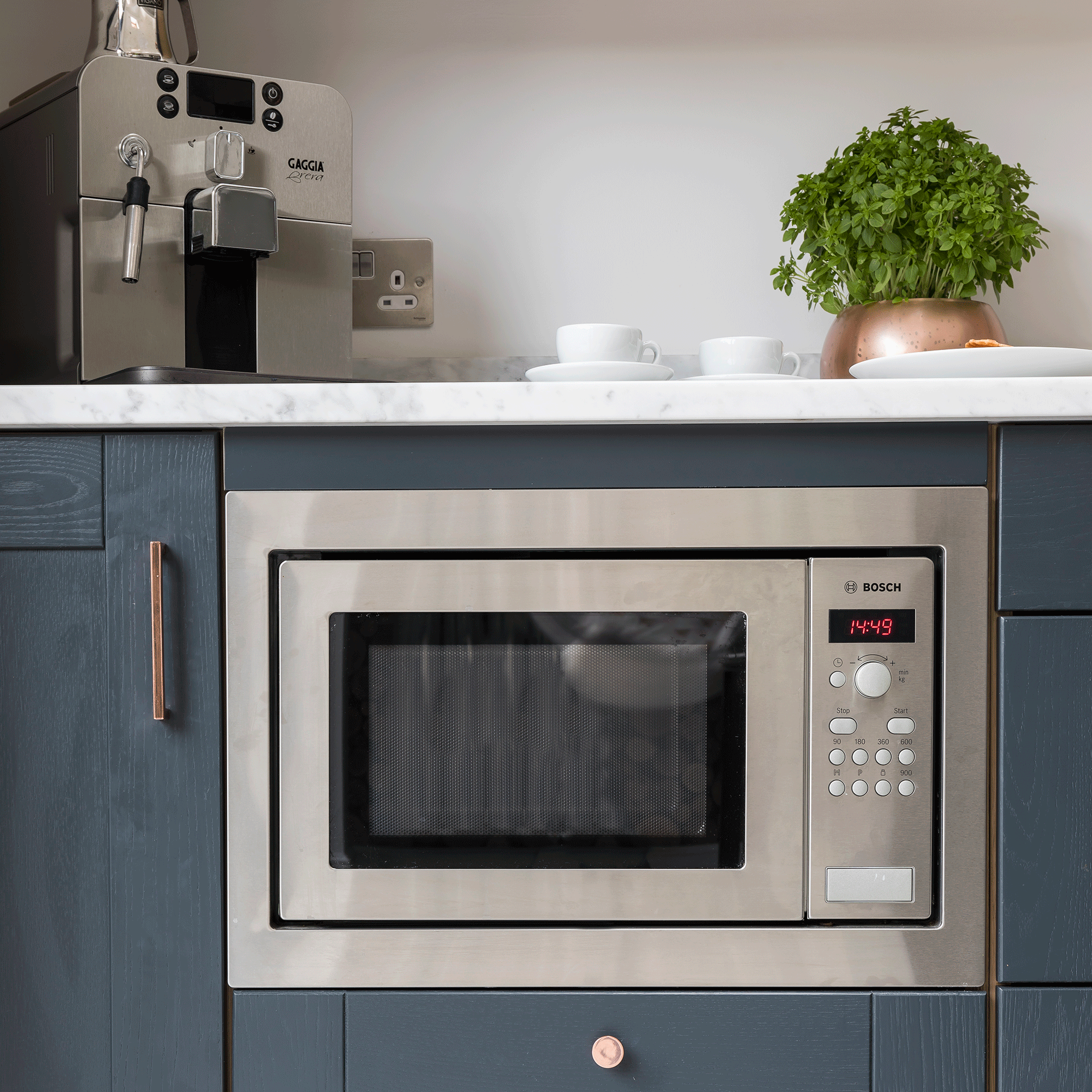 Microwave in a blue kitchen 