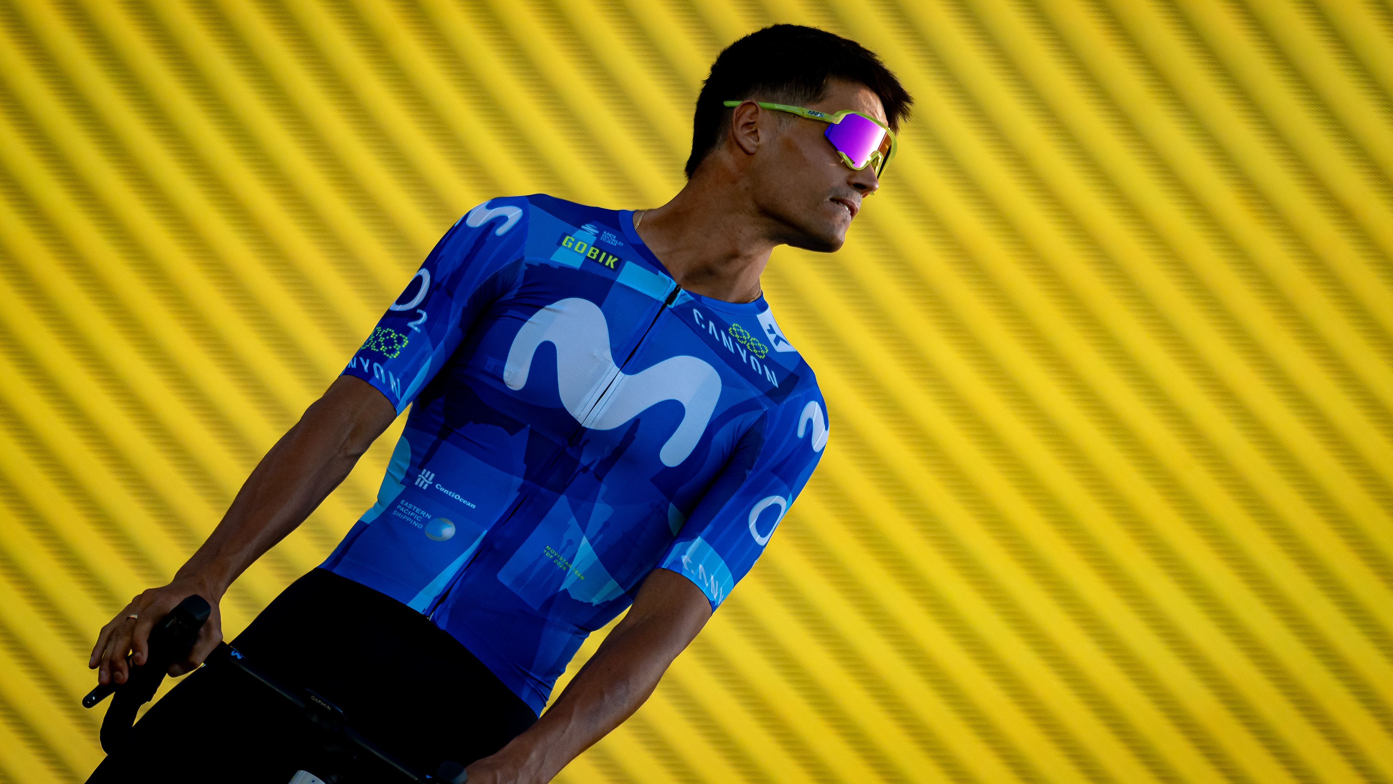 Javier Romo of the Movistar Team stands on stage in front of the Sagrada Familia basilica during the Tour de France 2026 team presentation ceremony