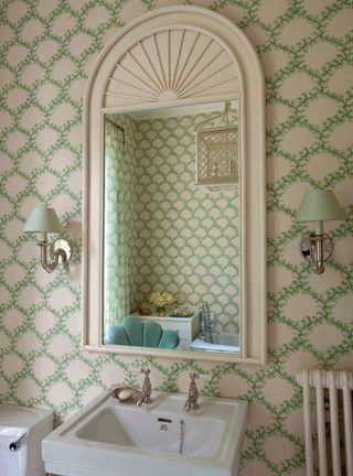 Bathroom with trellis wallpaper and mirror