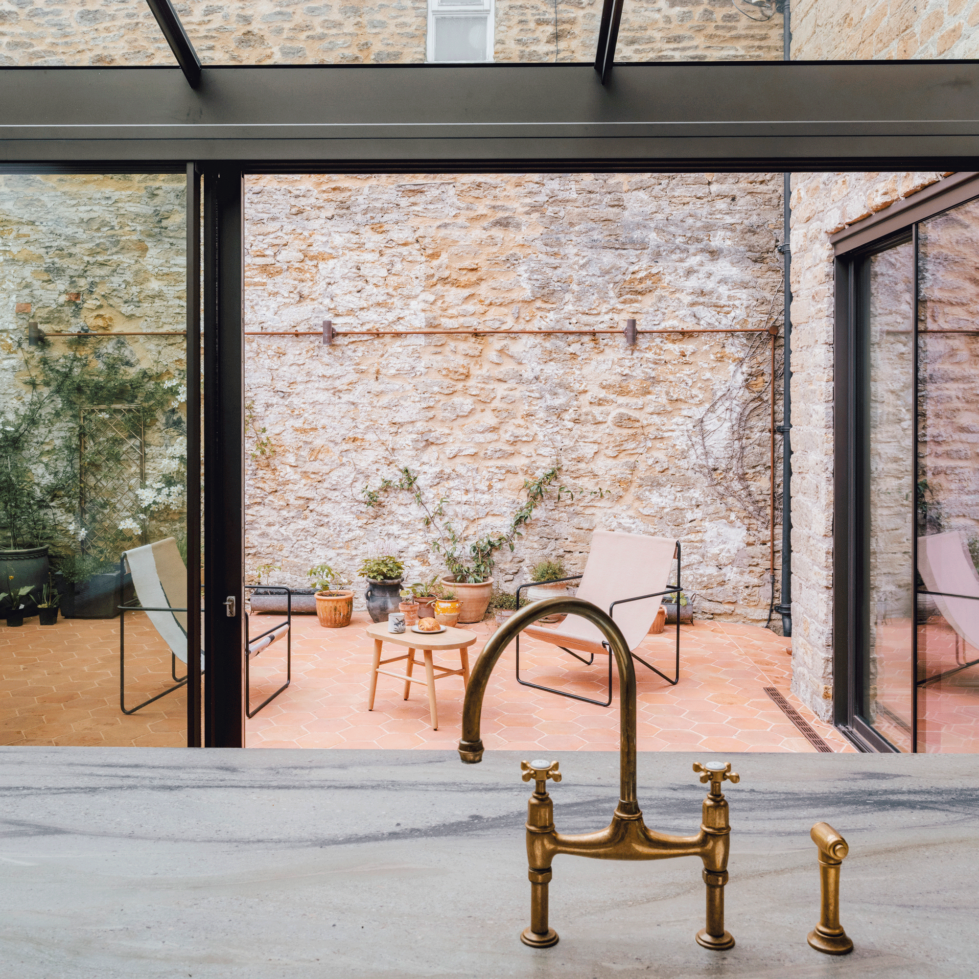 the view into a small patio courtyard from an open plan kitchen