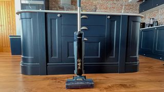 beldray all in one floor cleaner stood upright in kitchen with navy cabinetry and wood effect lvt flooring