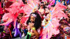 Revellers take part in the Notting Hill Carnival in London, England