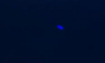 The blue light made erratic back-and-forth movements in the night sky before disappearing, a witness says.