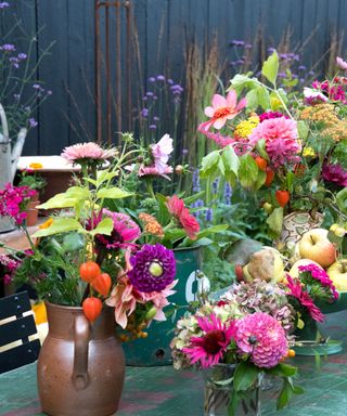 garden table with lots of flowers in vases