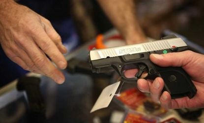 A customer shops for a pistol at a sporting goods store in Illinois on Dec. 17.