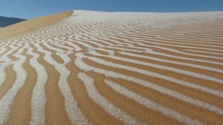 Ice streaks the sand dunes of the Sahara Desert in northwestern Algeria.