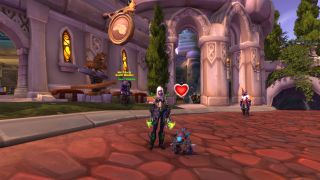 WoW Happy Pet treats - a demon hunter character is standing next to the Gilvanas battle pet in Dalaran. The pet has a red heart floating above it