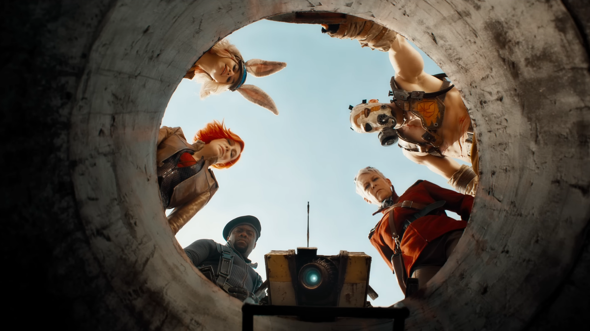 The cast of Borderlands stare down a manhole and into the camera.