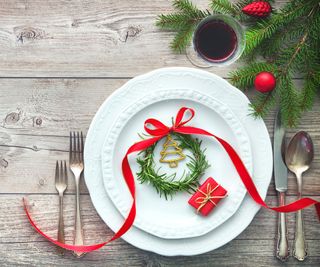 festive rosemary table decor with plate and cutlery