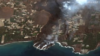 Lava from the erupting Cumbre Vieja volcano on the Spanish island of La Palma can be seen flowing into the Atlantic Ocean in this image captured by satellites by U.S. Earth observation company Maxar Technologies.