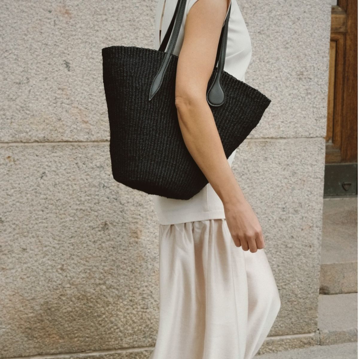 Johannaw wearing white dress and black basket bag