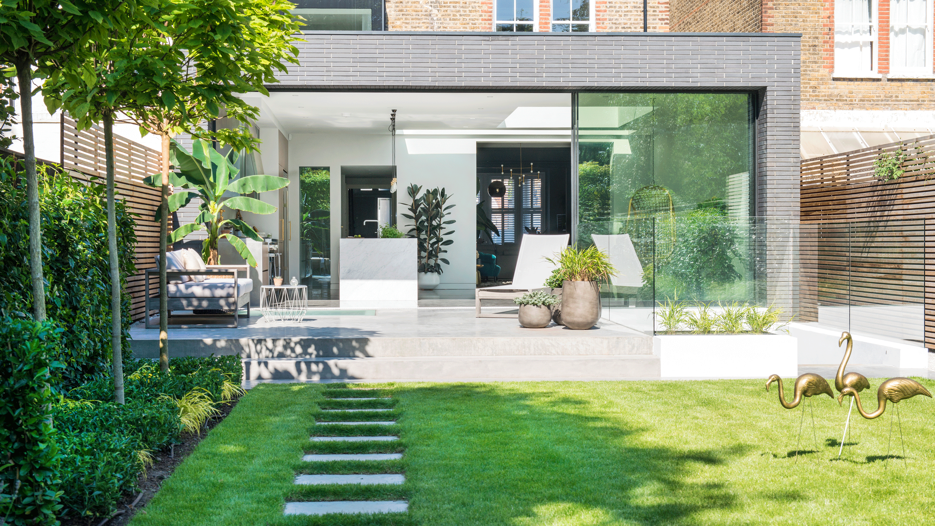 lawn with patio area and hammock in back garden