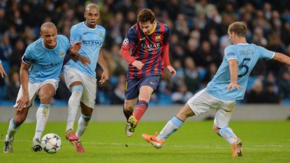 Barcelona's Argentinian forward Lionel Messi (2nd R) in action during a UEFA Champions League Last 16, first leg football match between Manchester City and Barcelona at The Etihad Stadium in 