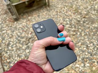 iPhone 12 mini gripped by one hand
