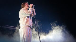 Lewis Capaldi singing on stage at the Mercedes-Benz Arena on Feb. 16, 2023.