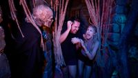 two guests getting scared while in haunted house at Universal Studios HHN
