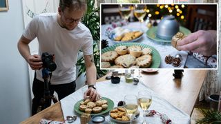 Man placing mince pie on plate, while holding camera. Inset image pf hand positioning Christmas decoration on table