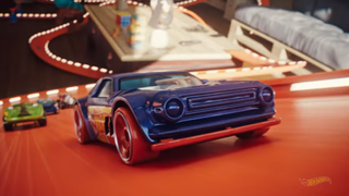 An image of Hot Wheels race cars on an orange plastic track from Hot Wheels Unleashed 2: Turbocharged. In the foreground is a blue and orange muscle car.