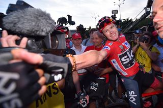 Teammates congratulate Chris Froome after the final Vuelta stage in Madrid