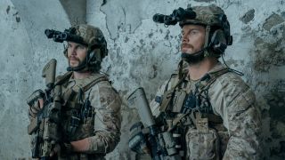 From left to right: Taylor Kitsch holding a gun and wearing a helment and Chris Pratt holding a gun and wearing a helmet in The Terminal List: Dark Wolf.