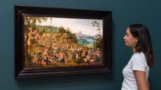 A young woman observes a painting in London Classics Week Old Masters show