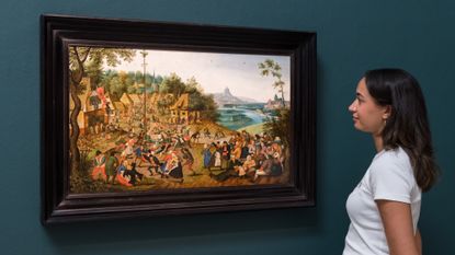 A young woman observes a painting in London Classics Week Old Masters show