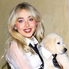 Sabrina Carpenter carries a puppy while wearing Thom Browne