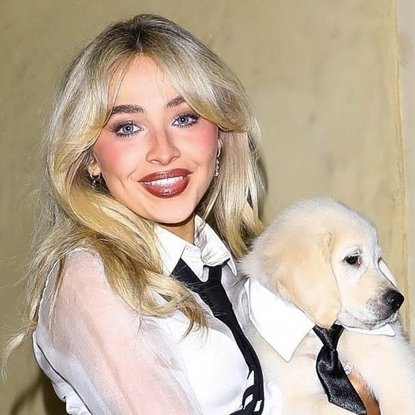 Sabrina Carpenter carries a puppy while wearing Thom Browne