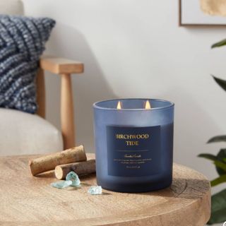 A navy blue candle on a wooden table