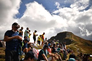 Spectators wait for the riders near the finish line in Puy Mary during the 13th stage of the 107th edition of the Tour de France cycling race, 191 km between Chatel-Guyon and Puy Mary, on September 11, 2020. (Photo by Anne-Christine POUJOULAT / AFP) (Photo by ANNE-CHRISTINE POUJOULAT / AFP)