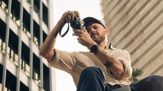 Photographer using the OM System OM-3 in an outdoor environment