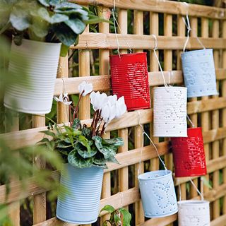 wooden trellis with red blue and white tin holders