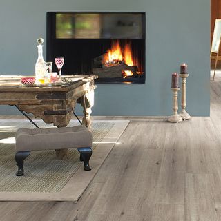 grey walled living room with wooden flooring and fire place