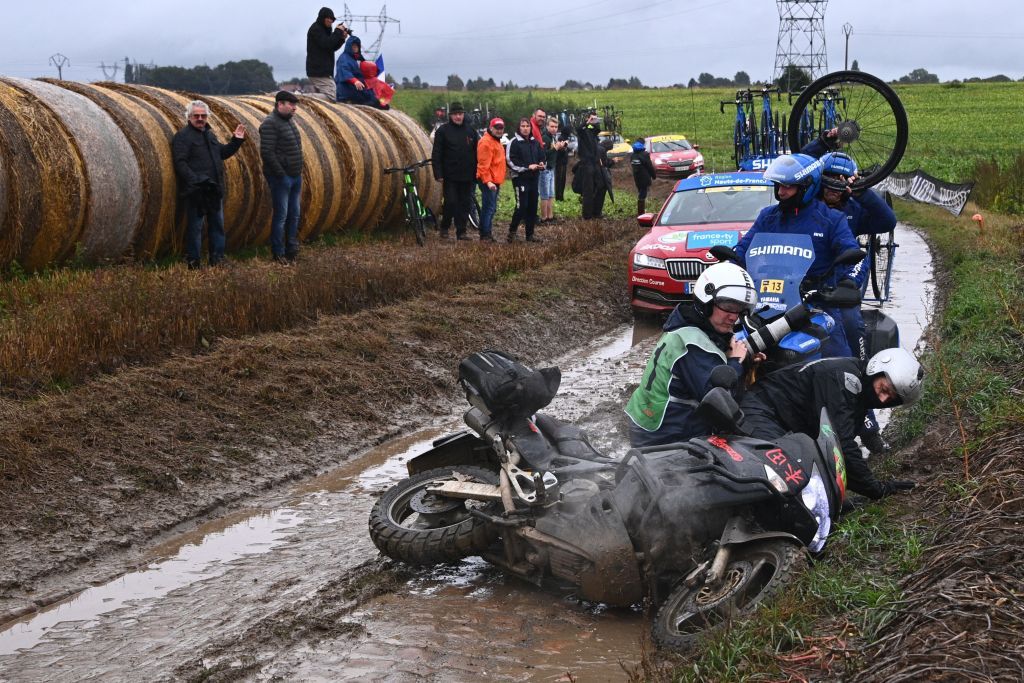 A motorbike carrying a photographer slips on the cobblestone during the 118th edition of the ParisRoubaix oneday classic cycling race between Compiegne and Roubaix northern France on October 3 2021 Photo by AnneChristine POUJOULAT AFP Photo by ANNECHRISTINE POUJOULATAFP via Getty Images