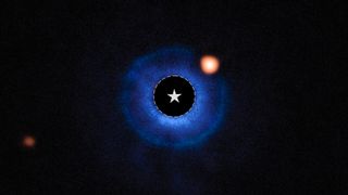 An orange glow of a potential new planet surrounding the blue dust rings of an star