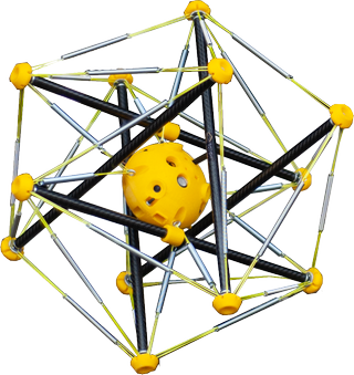A close-up of the squishy robot, which looks like a yellow ball surrounded by many poles of a frame that forms a prism around the center.