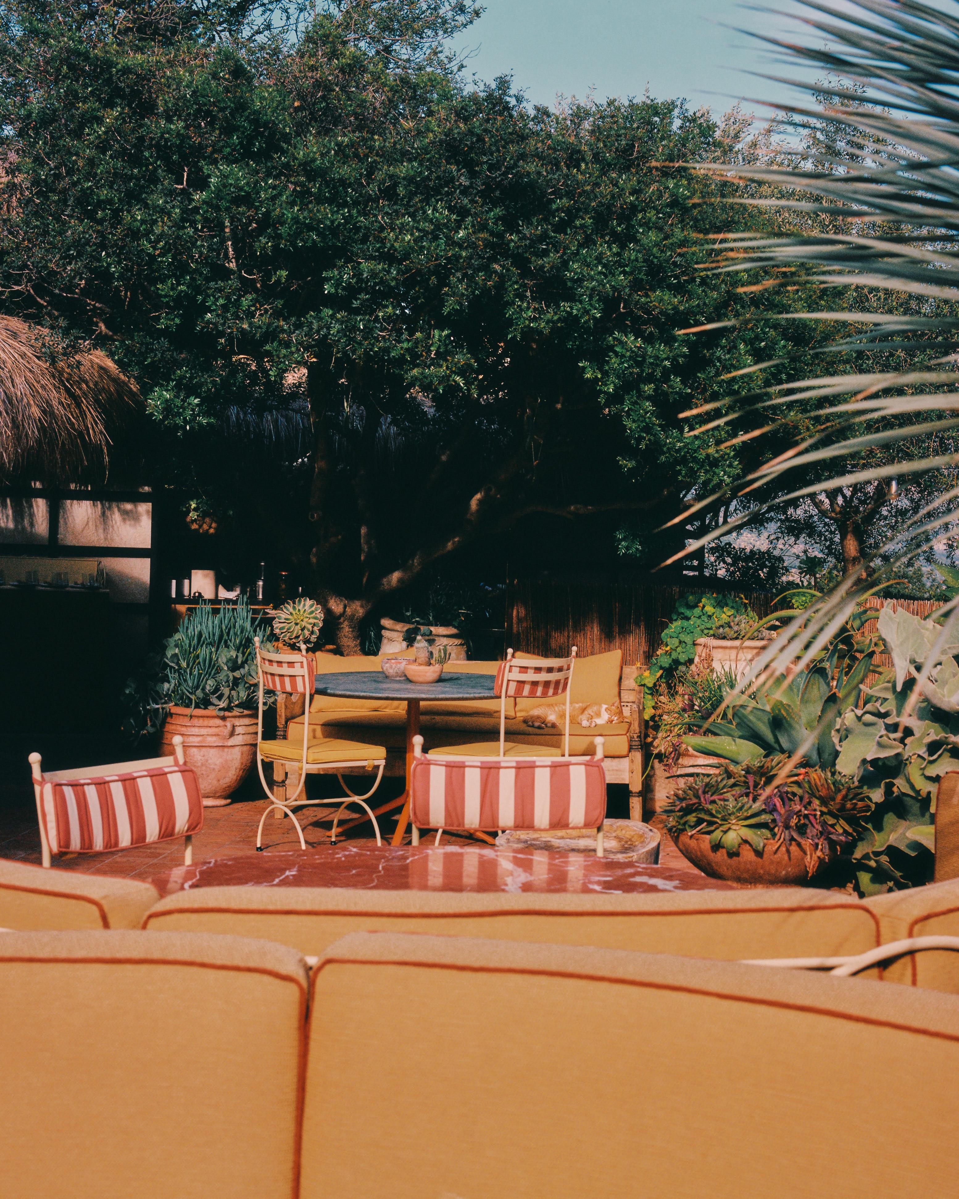 upholstered seating, tables and steel frame chairs on sunny terrace restaurant