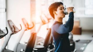 man-drinking-protein-shake-in-gym
