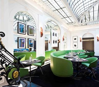 Hotel Vernet, dinning space with green seating chairs and and floor rug
