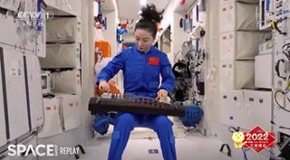 Chinese astronaut Wang Yaping performs the traditional folk song "Jasmine Flower" on a guzheng as part of a Lantern Festival celebration on the Tianhe module of the Tiangong space station during the Shenzhou 13 mission on Feb. 15, 2022.