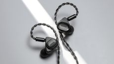 Product photography of the Activo Volcano earphones in black on a grey background