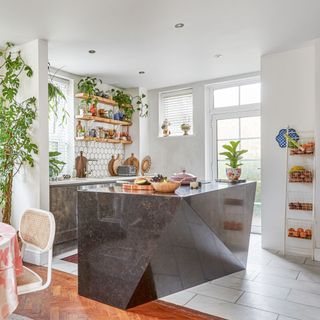 Kitchen-diner with angled marble-effect kitchen island and open shelving