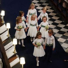 Bridesmaids and page boys Princess Charlotte of Cambridge, Savannah Phillips, Prince George of Cambridge, Maud Windsor, Isla Phillips, Mia Tindall, Theodora Williams and Louis de Givency walk up the aisle after the wedding of Jack Brooksbank and Princess Eugenie of York at St. George's Chapel on October 12, 2018 in Windsor, England