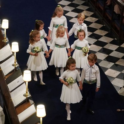 Bridesmaids and page boys Princess Charlotte of Cambridge, Savannah Phillips, Prince George of Cambridge, Maud Windsor, Isla Phillips, Mia Tindall, Theodora Williams and Louis de Givency walk up the aisle after the wedding of Jack Brooksbank and Princess Eugenie of York at St. George's Chapel on October 12, 2018 in Windsor, England