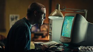 A man stares at a video game on his computer