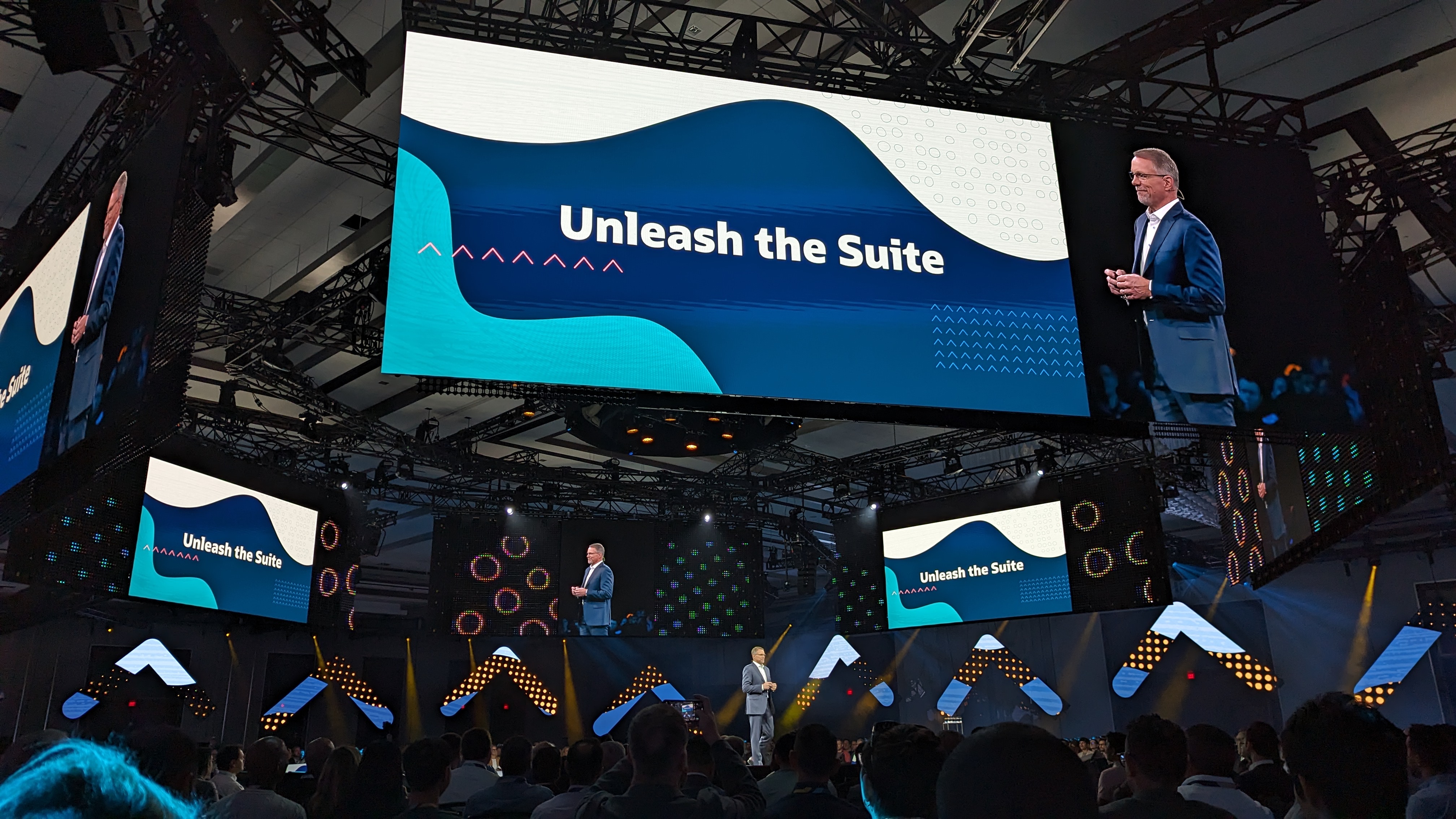 Gary Wiessinger, SVP, NetSuite application development, under a large screen reading 'Unleash the Suite' at SuiteWorld 2023.