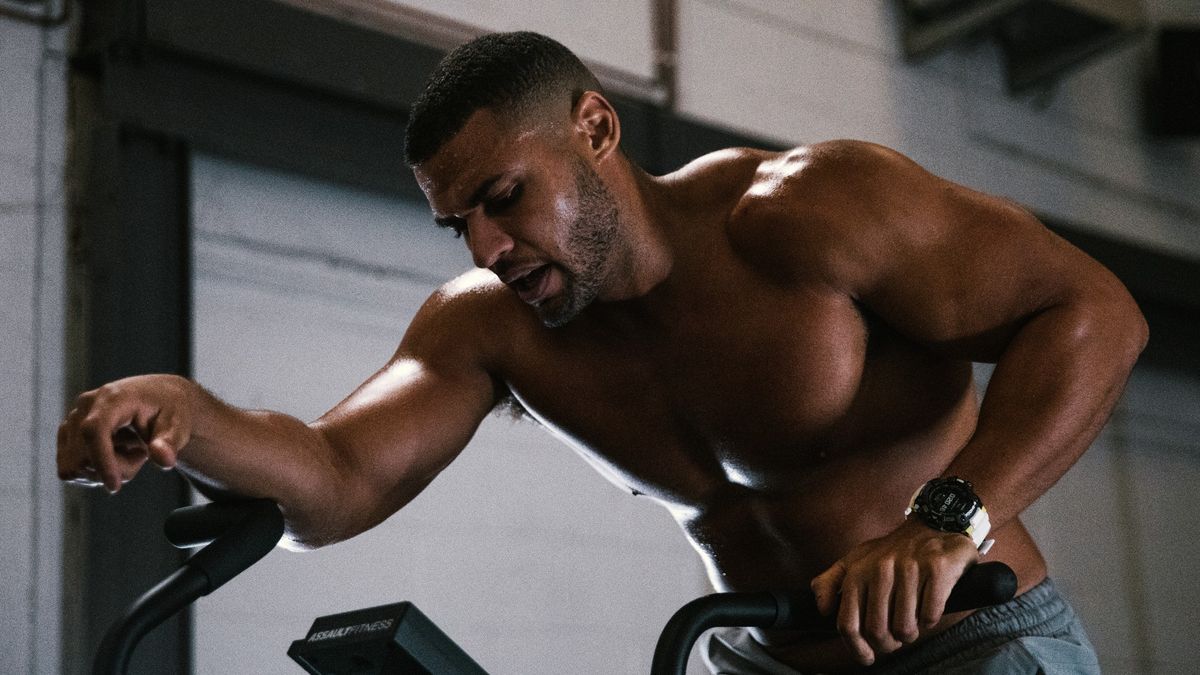 Dumbbell workout: Image of Zack George on an air dyne working out